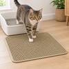 Tabby cat stepping out of the litter tray onto the khaki honeycomb litter mat