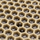 Close-up of the honeycomb cells holding litter grains