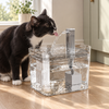 Cat drinking from the running stream at the top of a transparent cat water fountain