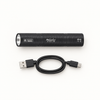 The black UV torch and its USB charging cable laid side by side