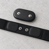 Polar H10 sensor unclipped from its strap, showing the two snap studs on the sensor and the matching snaps and electrode pads on the strap