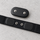 Polar H10 sensor unclipped from its strap, showing the two snap studs on the sensor and the matching snaps and electrode pads on the strap