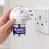 A hand holding the FELIWAY Optimum diffuser next to a UK wall socket