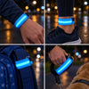 LED armbands glowing at night on a wrist, an ankle, a school bag strap and a dog lead handle