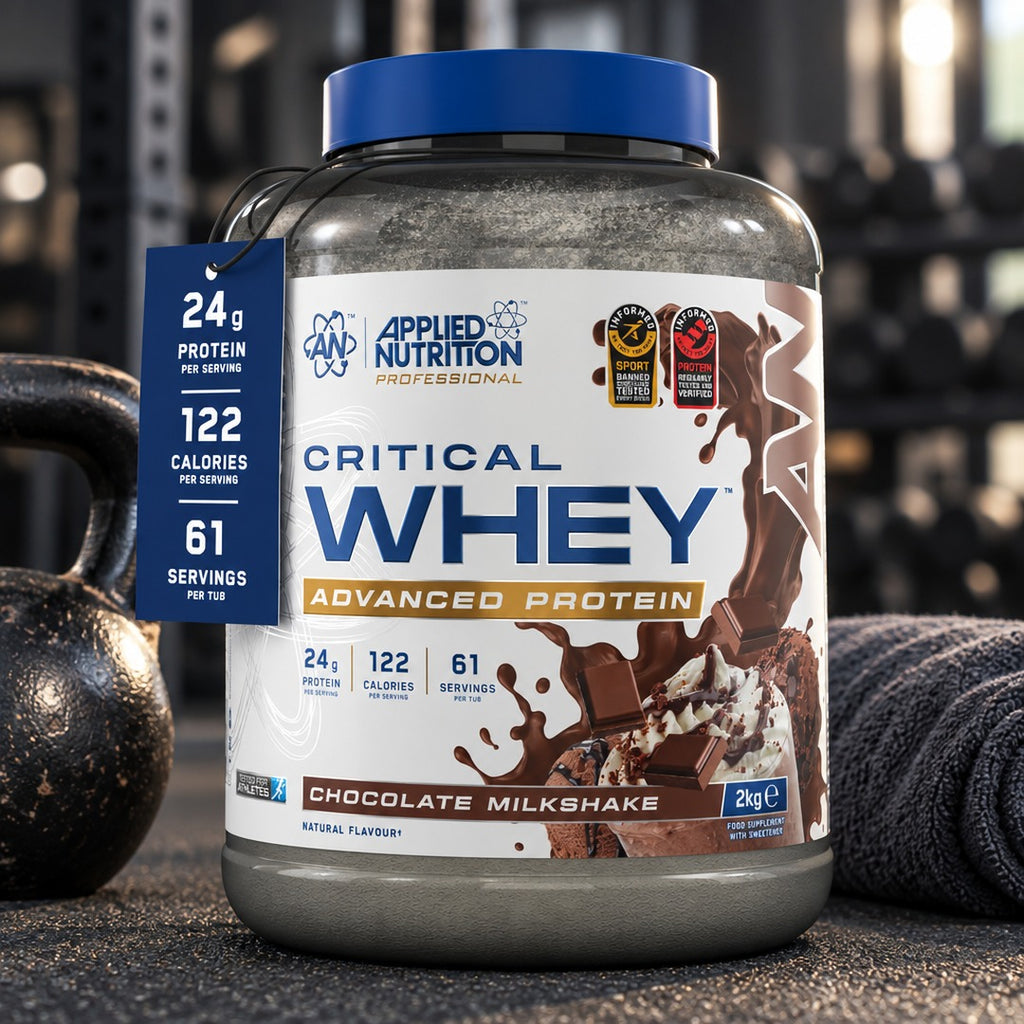 Applied Nutrition Critical Whey 2kg Chocolate Milkshake tub on a gym floor