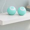A blue self-rolling ball charging on a shelf from a USB cable