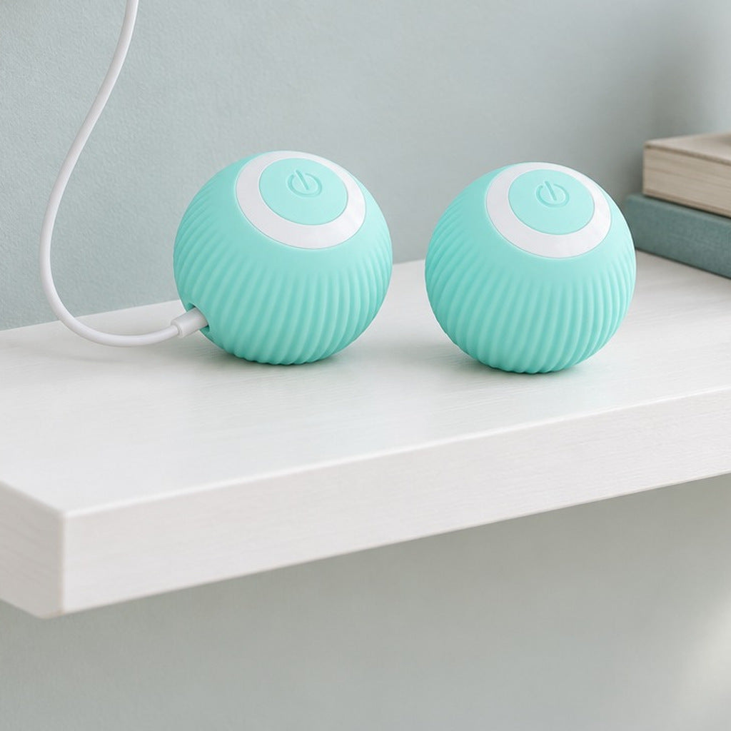 A blue self-rolling ball charging on a shelf from a USB cable