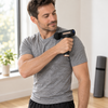 A person using the massage gun on the shoulder at home