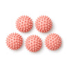Five pink spiky massage balls on white