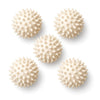 Five cream spiky massage balls on white
