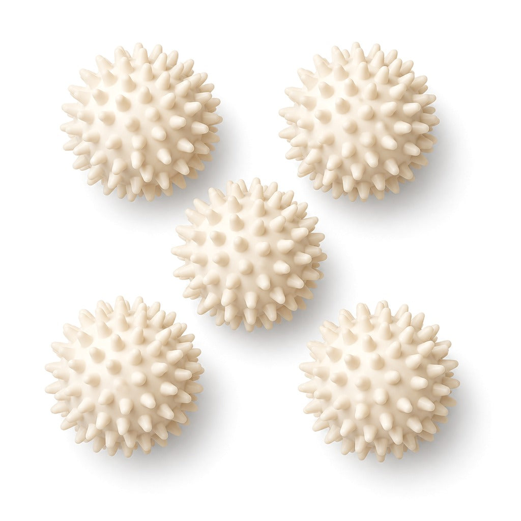 Five cream spiky massage balls on white
