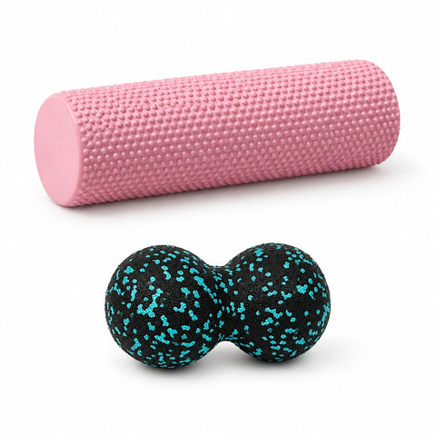 Pink foam roller and blue peanut massage ball on white