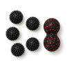 Five black spiky massage balls and a red peanut massage ball on white