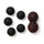 Five black spiky massage balls and a red peanut massage ball on white