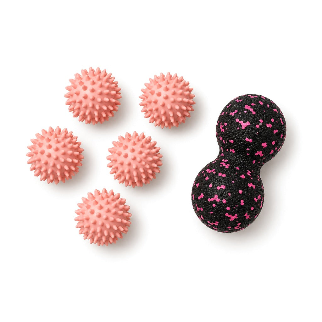 Five pink spiky massage balls and a pink peanut massage ball on white