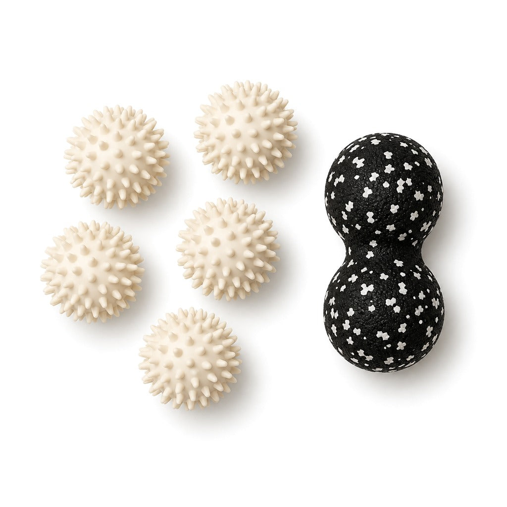 Five cream spiky massage balls and a white peanut massage ball on white