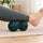 Resting a calf on the peanut massage ball on the floor