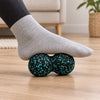 Sole of a foot rolling over a peanut massage ball