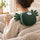 Person seated wearing the kneading neck and shoulder massager