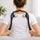 Two-ball massage tool draped over the shoulders, held by its handles
